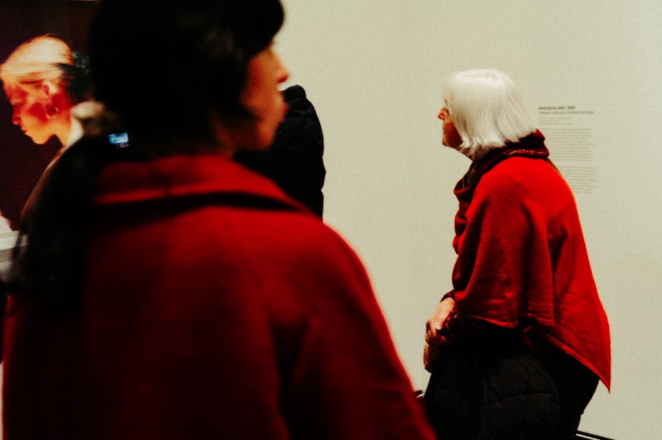 Two women in red, shallow depth of field
